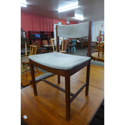 104 - A teak extending dining table and six chairs