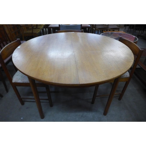 105 - A McIntosh teak extending dining table and six chairs