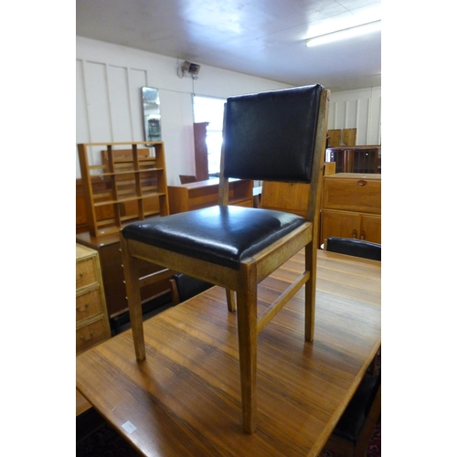 116 - A Gordon Russell walnut extending dining table and four chairs