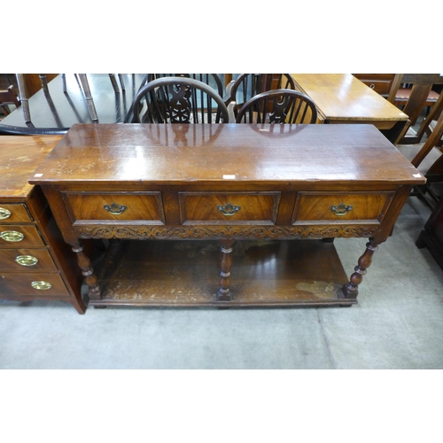 188 - A Jacobean Revival carved oak three drawer dresser