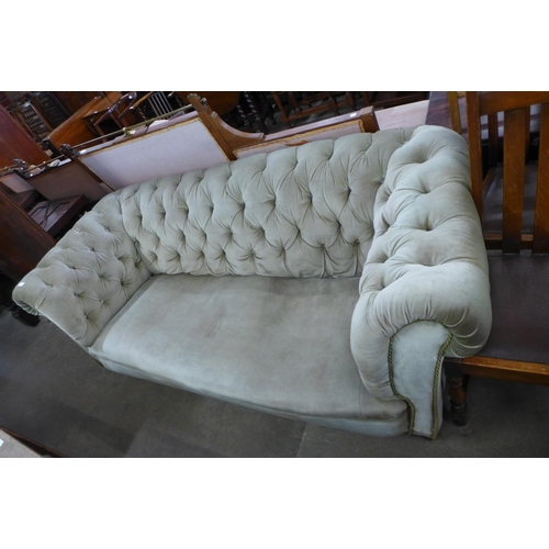 216 - A Victorian green fabric upholstered Chesterfield settee