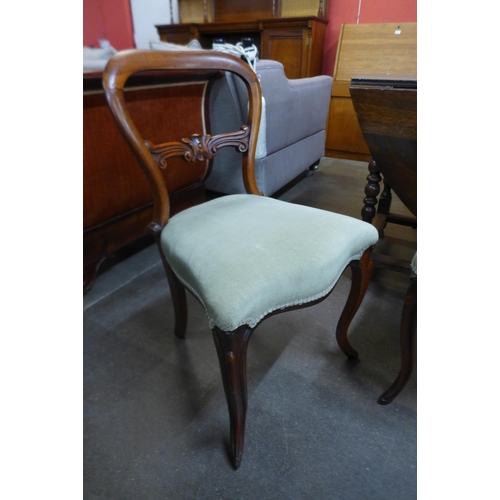 23 - A set of four Victorian rosewood kidney back dining chairs