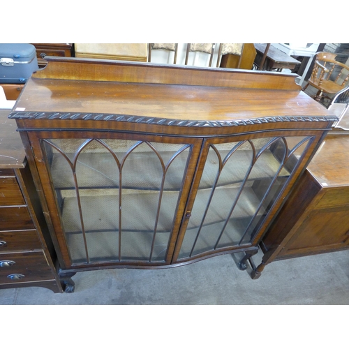 238 - An oak sideboard and a walnut serpentine display cabinet