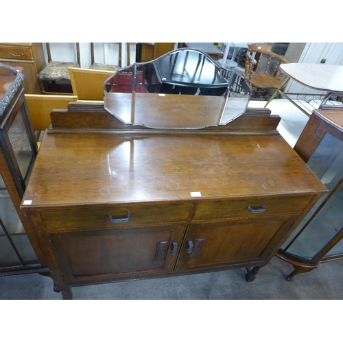 238 - An oak sideboard and a walnut serpentine display cabinet