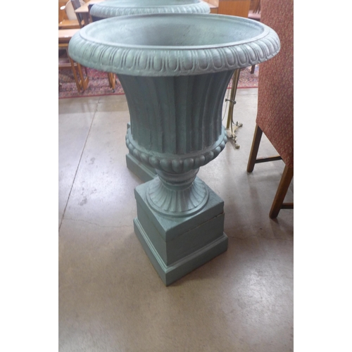 297 - A pair of painted cast iron campana shaped garden urns on stands, 105cms h x 61cms w