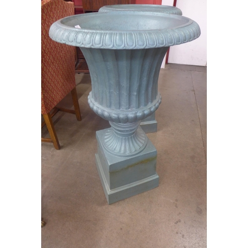 297 - A pair of painted cast iron campana shaped garden urns on stands, 105cms h x 61cms w