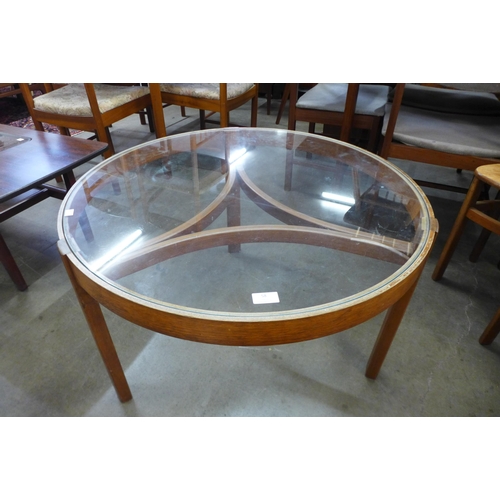 58 - A Nathan teak and glass topped circular nest of tables