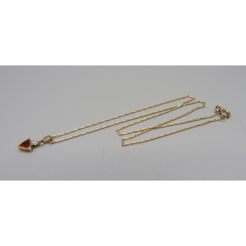 872 - A 9ct gold, diamond and red stone pendant and chain, 2.1g