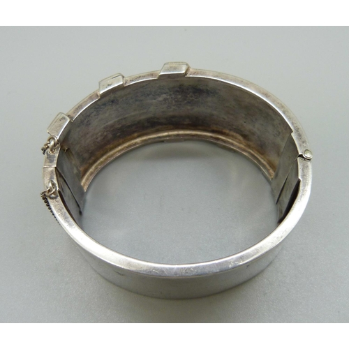 895 - A Victorian bangle with gold applied decoration, 31mm wide, opening 46mm x 55mm