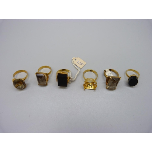 910 - Six gilt rings, including smoky quartz and onyx set, one marked 925, one marked silver and one lacki... 