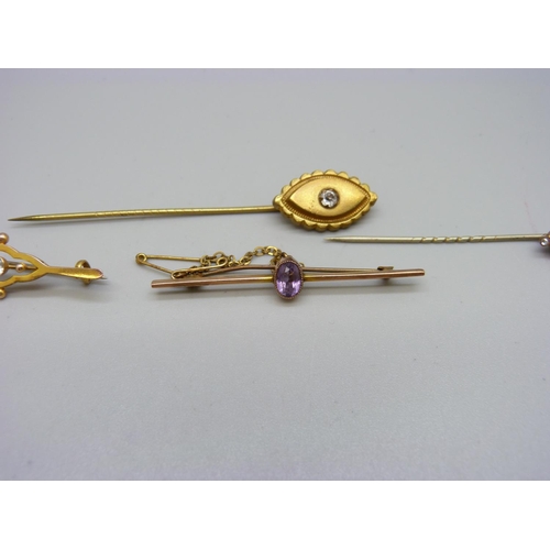 924 - A 9ct gold bar brooch set with an amethyst, a 9ct gold brooch set with a blue stone, 4g, and two sti... 