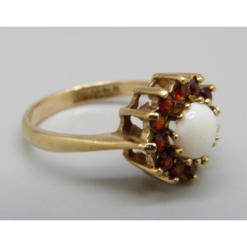 973 - A 9ct gold garnet and opal cluster ring, 2.5g, M