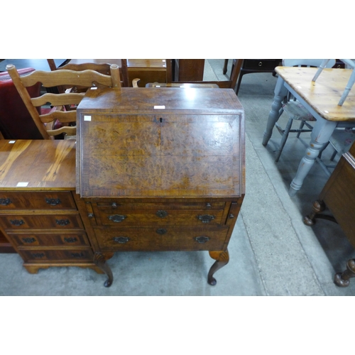 103 - A Queen Anne style figured walnut bureau de dame