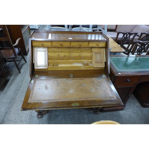 104 - An early 20th Century carved oak cantilever action bureau