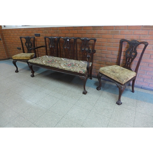 105a - A Chippendale style carved mahogany chair back settee and a pair of side chairs