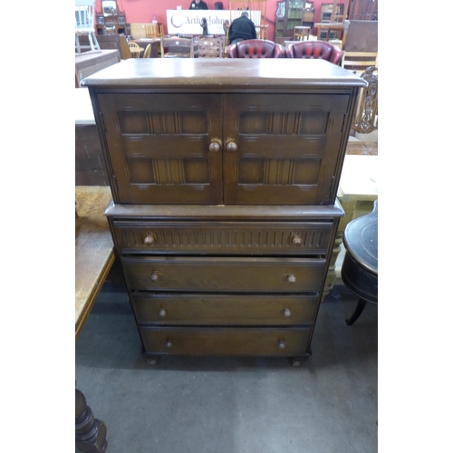 241 - An oak draw-leaf table and a carved oak tallboy