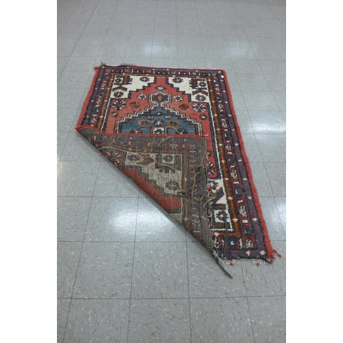 248 - A hand knotted red ground rug