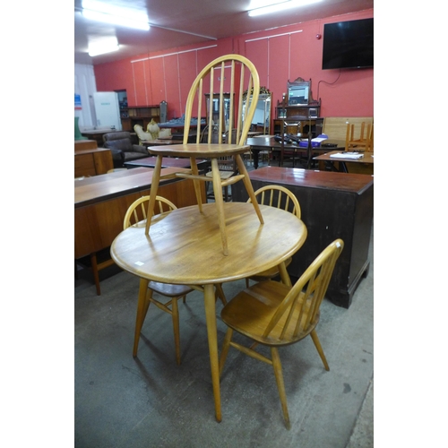 81 - An Ercol Blonde elm and beech oval table and four Ercol Windsor chairs