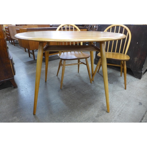 81 - An Ercol Blonde elm and beech oval table and four Ercol Windsor chairs