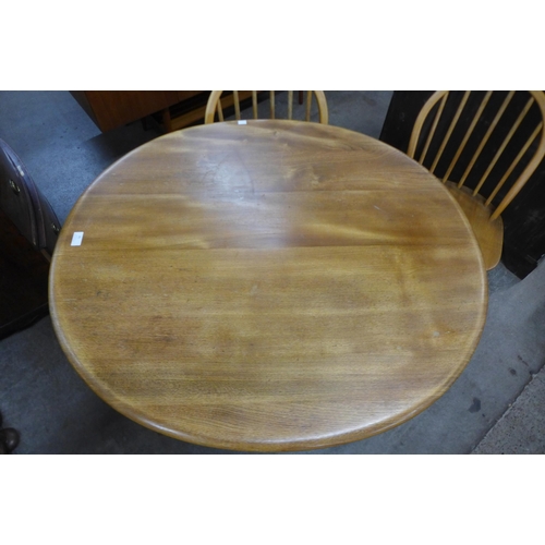 81 - An Ercol Blonde elm and beech oval table and four Ercol Windsor chairs