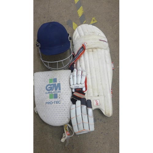 2082 - Large quantity of cricket pads & helmet with 2 bags