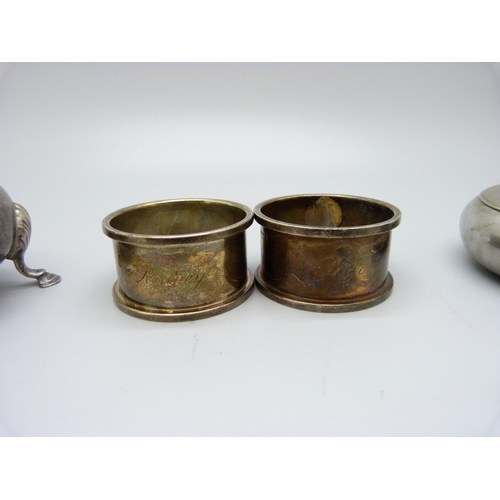 859 - Two silver napkin rings, a silver salt, (119g of silver), and a tobacco box