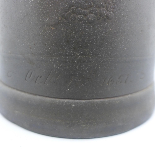 641 - A 17th Century two handled tankard, a/f, with worn inscription, 'At The Man And Scythe Sacred to The... 