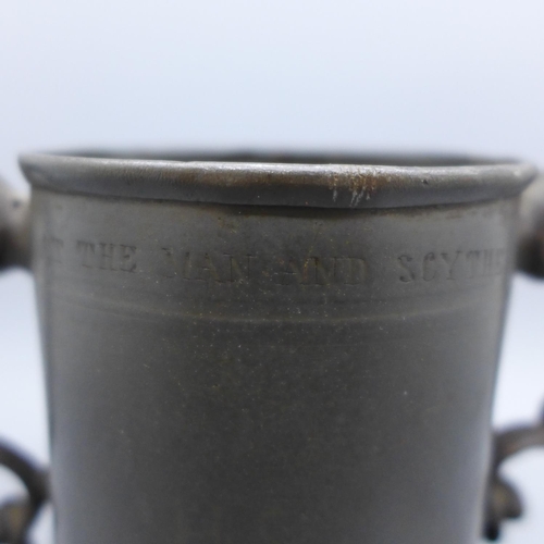 641 - A 17th Century two handled tankard, a/f, with worn inscription, 'At The Man And Scythe Sacred to The... 