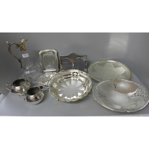 665 - A collection of plated ware including a Walker & Hall basket, a claret jug with plated top, etc.