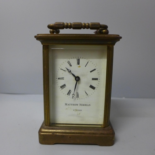 680 - A Matthew Norman four glass sided brass timepiece, boxed