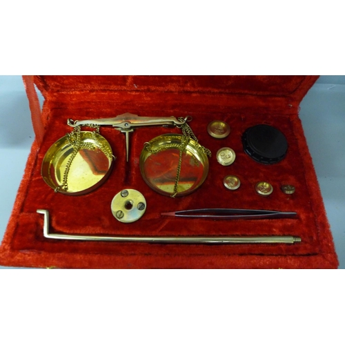 691 - A cased set of scales with weights, and one other set of scales