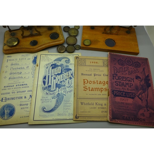 702 - Two sets of postal scales and weights and early 20th Century stamp price guides