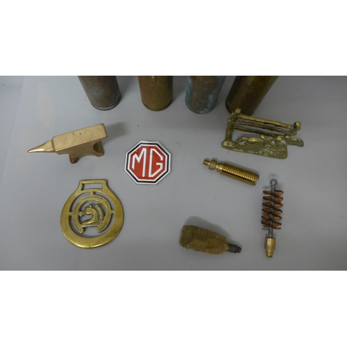 713 - Four military shell cases, etc.