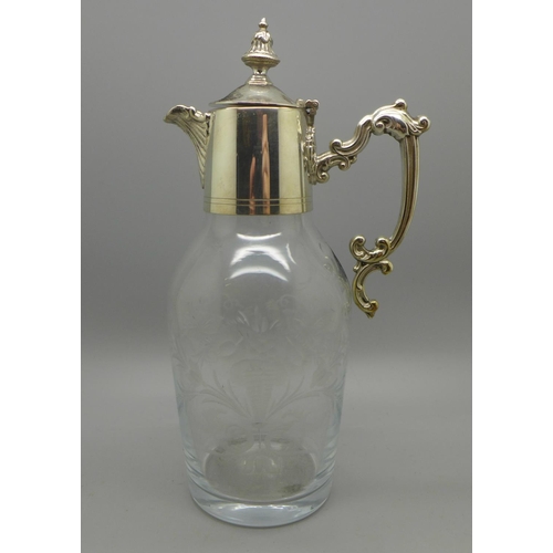 777 - A small cut glass jug with silver plated top