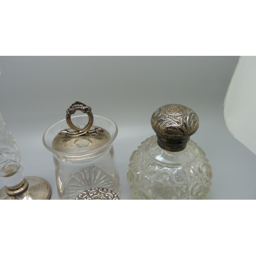 830 - A silver topped preserve jar, a silver mounted glass posy jar, etc., (scent bottles a/f)