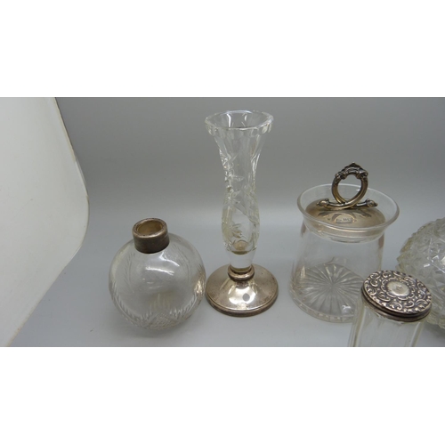 830 - A silver topped preserve jar, a silver mounted glass posy jar, etc., (scent bottles a/f)