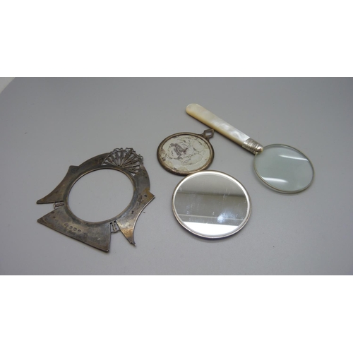 848 - A magnifying glass with mother of pearl handle and silver mount, a silver backed handbag mirror, a s... 