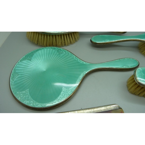 849 - A silver and enamel dressing table set, mirror, four brushes and a comb