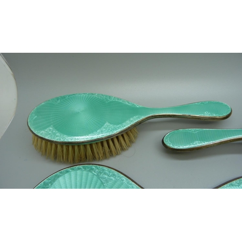 849 - A silver and enamel dressing table set, mirror, four brushes and a comb