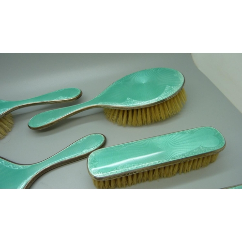 849 - A silver and enamel dressing table set, mirror, four brushes and a comb