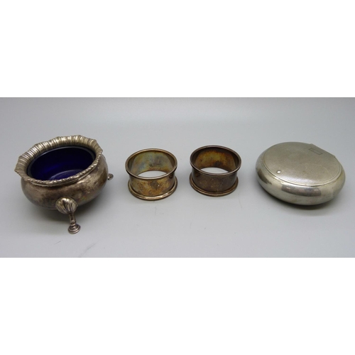 859 - Two silver napkin rings, a silver salt, (119g of silver), and a tobacco box