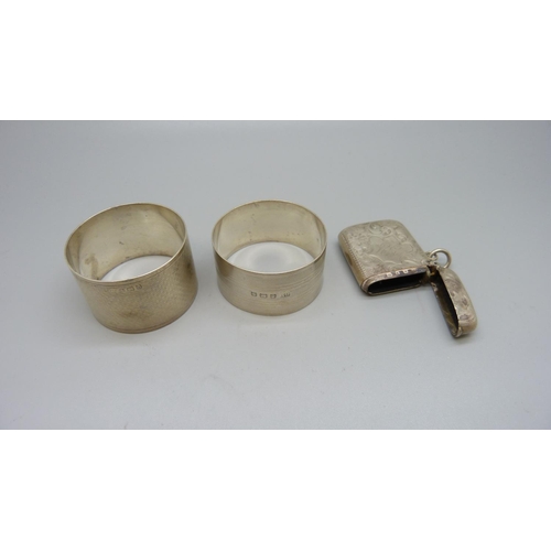 872 - A silver vesta case, Birmingham 1899, and two silver napkin rings including one George Unite, 66g