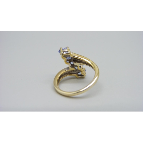 960 - A silver gilt, five stone tanzanite ring with diamond accents, L