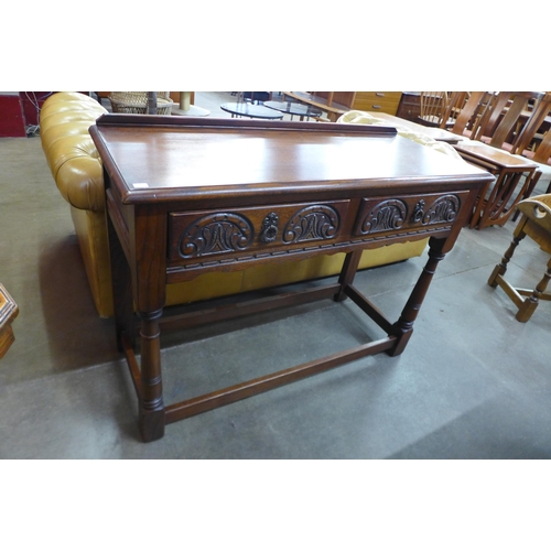 106 - An Old Charm carved oak two drawer serving table