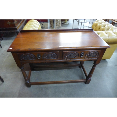 106 - An Old Charm carved oak two drawer serving table