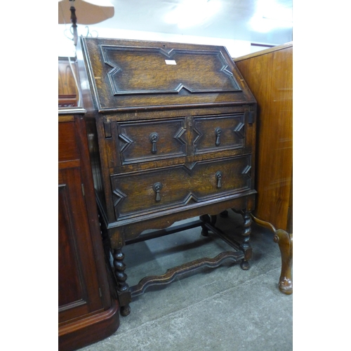 113 - A carved oak geometric moulded bureau