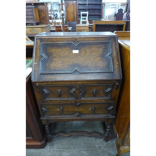 113 - A carved oak geometric moulded bureau