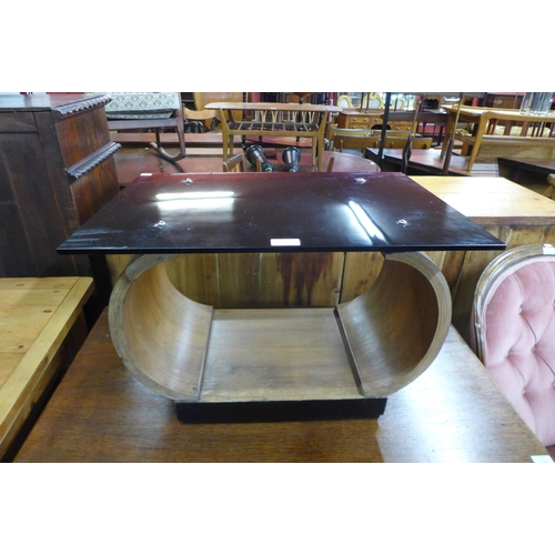 128 - An Art Deco style bent plywood and black glass topped occasional table