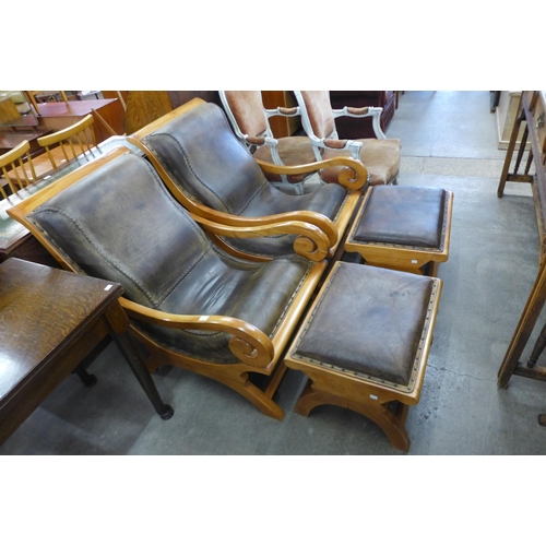 136 - A pair of hardwood and leather upholstered open armchairs and matching footstools