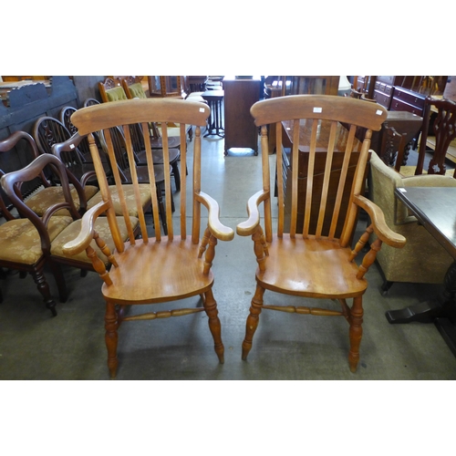 140 - A pair of beech farmhouse armchairs